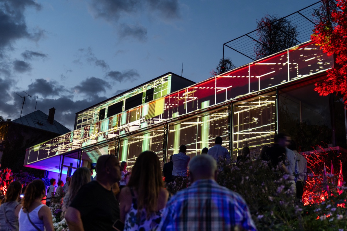 Building facade lit with a projected light show at dusk