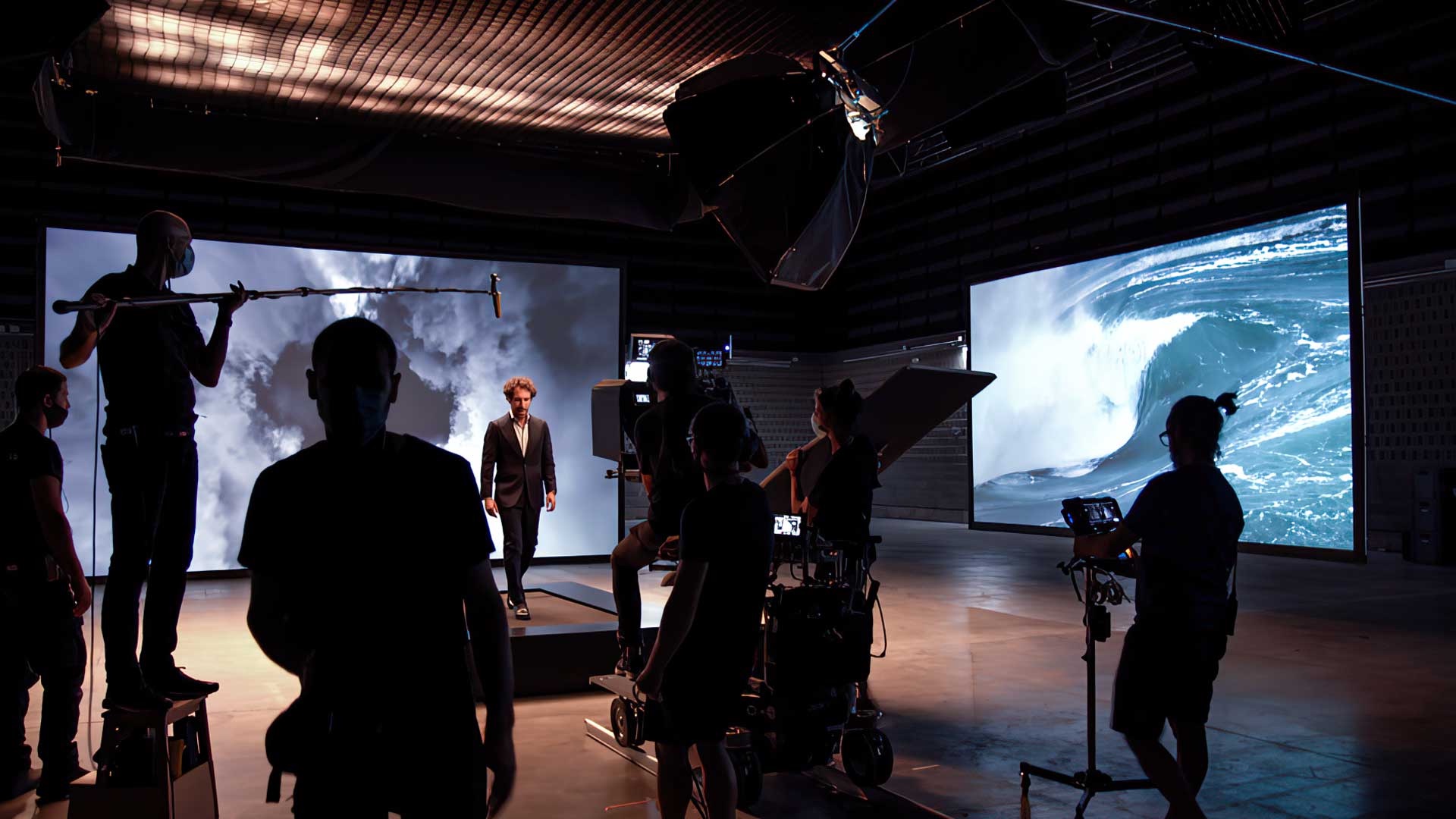 Deeper Vision crew setting up projection screens in a studio