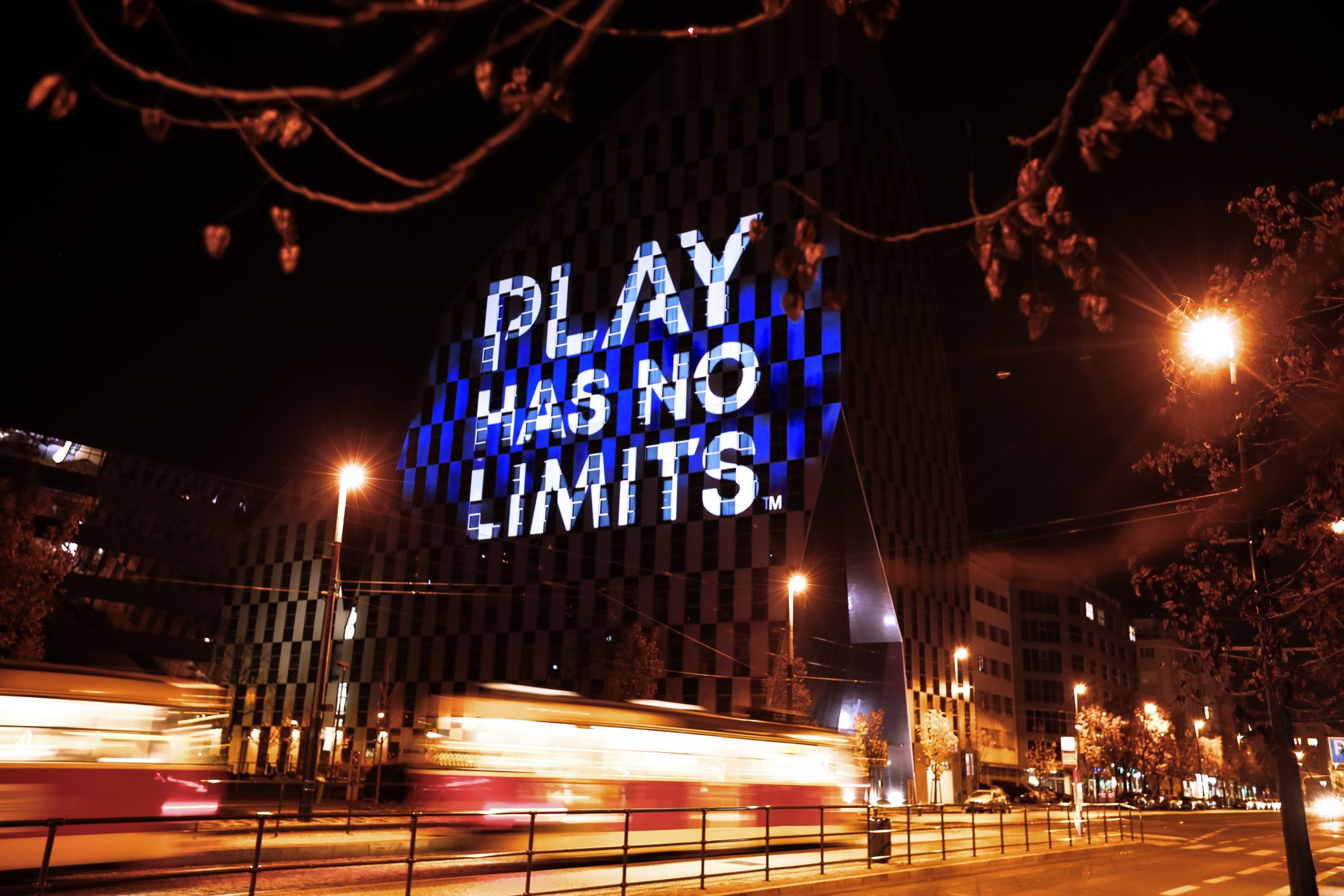 “Play has no limits” projected on a building facade in Prague